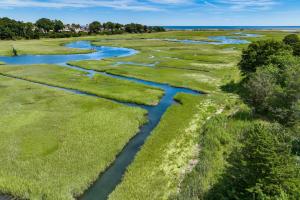 an aerial view of a river in a field at Marshside Cape Escape with Space Views in Sandwich