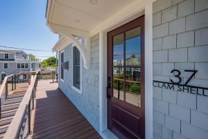 a front porch of a building with a door at Slow M'Ocean – A Fresh Take on Cape Calm in Chatham