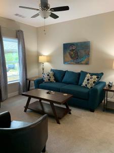 a living room with a blue couch and a table at Valhalla Resort Hotel in Helen +26 photos