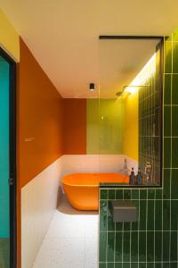 a bathroom with an orange tub and a sink at Lot 78 in Malacca +95 photos