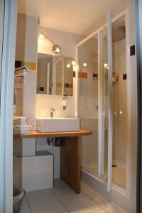 a bathroom with a sink and a shower at Hôtel Vauban in Le Palais