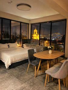a bedroom with a bed and a table with a view at Apartment Natali Inn in Tbilisi City