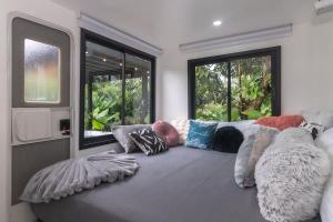 a living room with a couch with pillows on it at Rolling Green Oasis in Fortuna