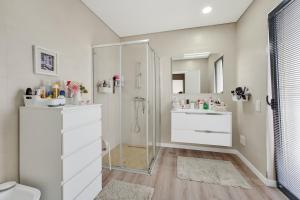 a bathroom with a shower and a sink and a toilet at Apartamento Cabine by Algarve Holidays in Quarteira +31 photos