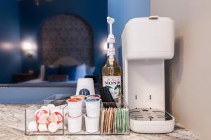 a counter with a bottle of wine and a mixer at Hollyhock Suite 406 in Louisville