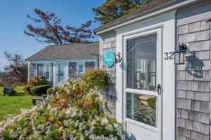 a front door of a house with a sign on it at Lost at Seaside – Your Cozy Coastal Hideaway in South Yarmouth