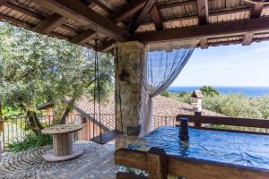 a patio with a table and a view of the ocean at Villa Privata con Giardino e Piscina in Trivio