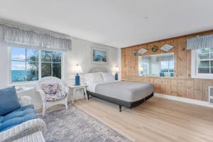 a bedroom with a bed and a couch at Oceans Edge: Drift, Dream, Repeat in South Yarmouth