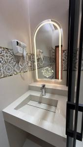 a bathroom with a sink and a mirror at Sahro Hotel Khiva in Khiva +21 photos