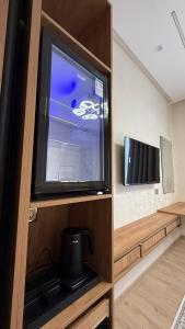 a large flat screen tv in a wooden entertainment center at Sahro Hotel Khiva in Khiva