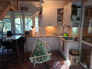 a kitchen with a hammock in the middle at Gomba Kert in Nagymaros