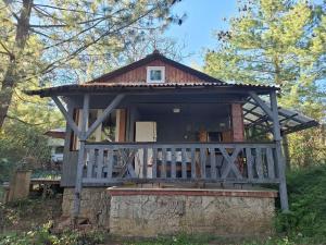 a tree house with a porch and a balcony at Gomba Kert in Nagymaros