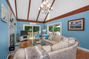 a living room with a couch and a fireplace at Cape Cod Escape – 1 Mile to Beach, A/C Grill in Centerville