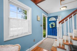 a blue room with a staircase and a window at Cape Cod Escape – 1 Mile to Beach, A/C Grill in Centerville