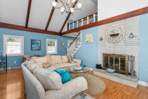 a living room with a couch and a fireplace at Cape Cod Escape – 1 Mile to Beach, A/C Grill in Centerville +38 photos