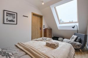 a bedroom with a large bed with a window at BANIA BLACK MOUNTAIN I basen & spa in Białka Tatrzańska +44 photos