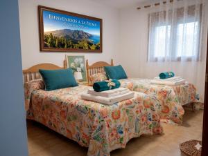a bedroom with two beds and a poster on the wall at Lago Azul 59 SEA VIEW LOS CANCAJOS in Los Cancajos +73 photos