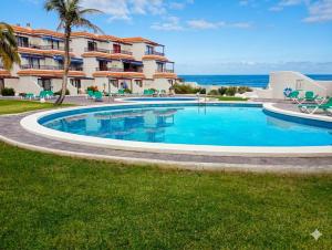 a swimming pool in front of a building at Lago Azul 59 SEA VIEW LOS CANCAJOS in Los Cancajos