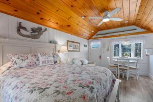 a bedroom with a bed and a wooden ceiling at Seaglass Cottage – Where Calm Meets Tide in South Yarmouth
