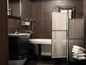 a bathroom with a sink and a toilet and a tub at Traku14 Old Town Yoga Studio in Vilnius +25 photos