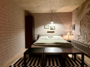 a bedroom with a bed and a table in it at Traku14 Old Town Yoga Studio in Vilnius
