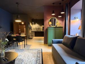 a living room with a couch and a table at Traku14 Old Town Yoga Studio in Vilnius