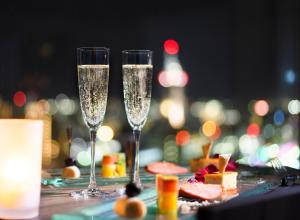 two glasses of champagne on a table with food at Toyama Excel Hotel Tokyu in Toyama