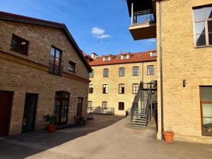 an alley between two brick buildings with a spiral staircase at Traku14 Old Town Yoga Studio in Vilnius