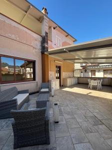 a patio with chairs and tables and a building at La casa di Caliddu in Torrenova