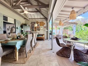 a dining room with a table and chairs at Villa Chic à Petit-Havre in Le Gosier