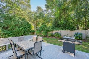 a patio with a barbecue and a table and chairs at On Cape Time – Family Friendly Relaxing Escape in Osterville