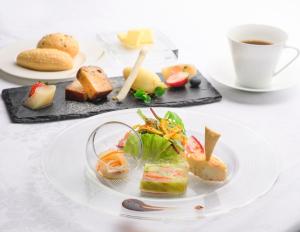a plate of food on a table with a cup of coffee at Toyama Excel Hotel Tokyu in Toyama