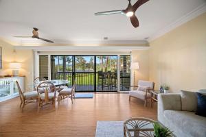a living room with a couch and a table and chairs at NEW Beachfront 2 Bedroom Ocean View Oasis and Pool in Kapaa