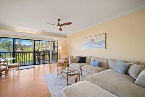 a living room with a couch and a table at NEW Beachfront 2 Bedroom Ocean View Oasis and Pool in Kapaa +47 photos