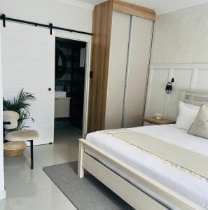 a bedroom with a bed and a sliding glass door at 15 On Candy in Midrand +10 photos