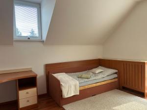 a small bedroom with a bed and a window at Dom pri Veži in Košice