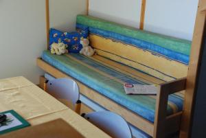 two stuffed animals sitting on a bed in a classroom at Chalet Aster 1 in Blavignac +36 photos