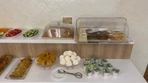 a shelf with a bunch of different types of food at Sahro Hotel Khiva in Khiva