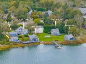an aerial view of a house on an island in the water at Charming Waterfront Escape Along the Cove in Eastham
