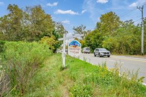 a sign on the side of a road with a car at Charming Waterfront Escape Along the Cove in Eastham