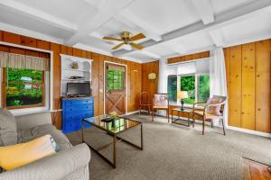 a living room with a couch and a table at Tranquil Eastham Waterfront Cottage Escape in Eastham