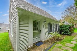 a small green house with a green door at Tranquil Eastham Waterfront Cottage Escape in Eastham +29 photos