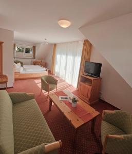 a living room with a couch and a table and a bed at Bürgerstüble in Sankt Peter