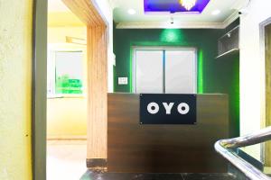 a door with the word oxo on it in a room at Hotel O Grand 55 in Bālianta