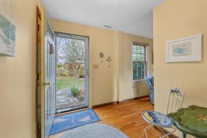 a living room with a door and a table and chairs at Spacious Dog-Friendly Retreat in Chatham in Chatham