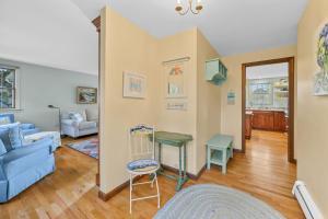 a living room with a blue couch and a table at Spacious Dog-Friendly Retreat in Chatham in Chatham +46 photos