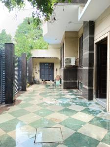 an empty courtyard of a house with a tile floor at Home By The Park in New Delhi
