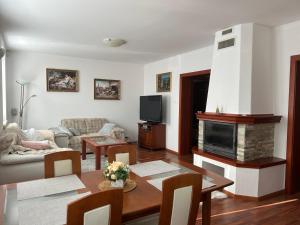 a living room with a table and a fireplace at Dom pri Veži in Košice