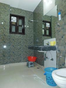 a bathroom with a sink and a toilet at Home By The Park in New Delhi +27 photos
