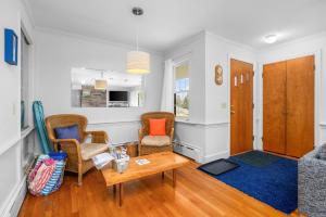a living room with two chairs and a table at Relaxing Barnstable Getaway Close to the Beach in Barnstable +23 photos